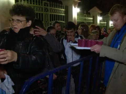 Ceai cald pentru pelerinii care stau la rând